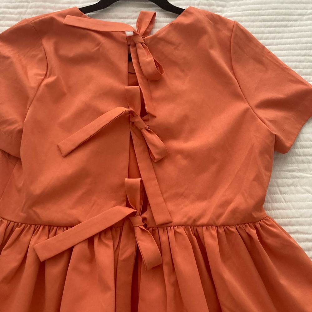 Anthropologie Coral peplum tie back top. Gorgeous color.